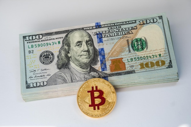 United States currency 100 dollar banknotes and bitcoin