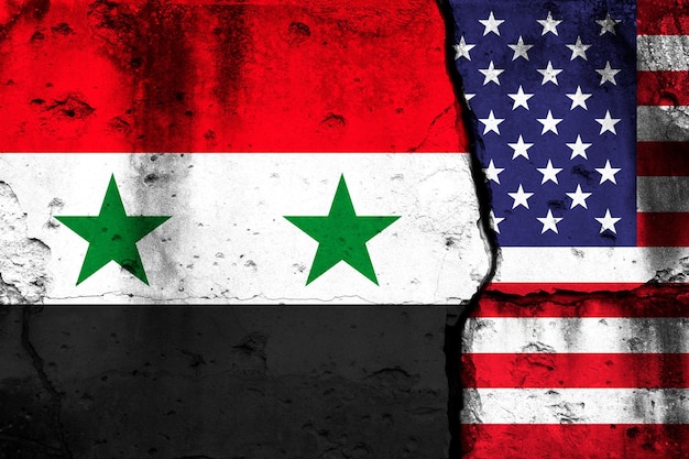 United States and Syria crisis Background with national flags on cracked wall photo