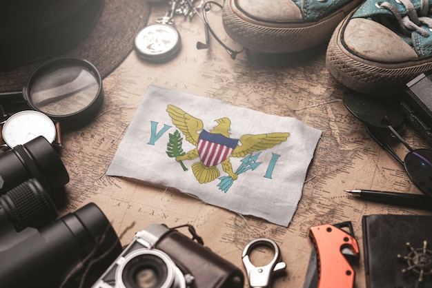 United States Virgin Islands Flag Between Traveler's Accessories on Old Vintage Map. Tourist Destination Concept.