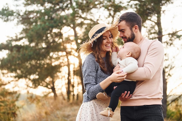 Unity of the people Happy family of mother family and little baby rests outdoors Beautiful sunny autumn nature