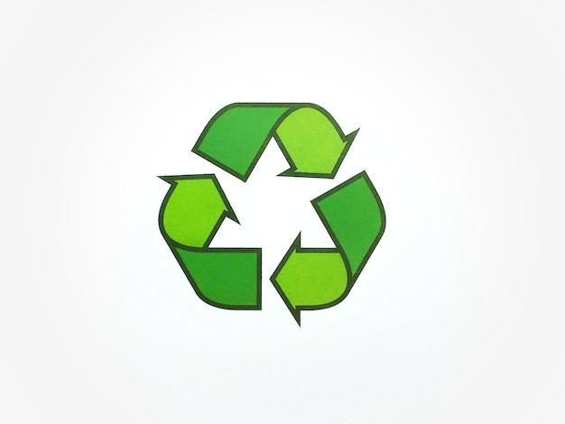 Universal recycling symbol with green arrows isolated on a white background and copy space for text