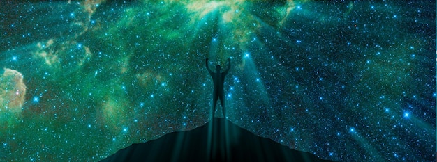 Universe and man achievements in selfknowledge mind meditation\
spiritual practices spiritual exercises man standing on top of\
mountain back view staring milky way