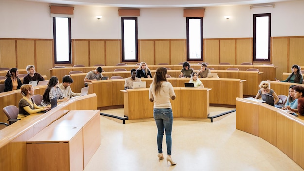 University class in a circular classroom with students of\
different origins and the teacher in the middle