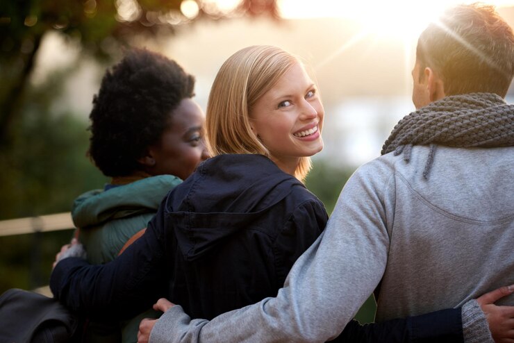 Photo university friends and portrait with hug or happy for bonding relax and break on campus with diversity college people and smile with embrace for support education and learning fun with rear view