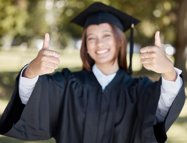 Photo university graduation and student with thumbs up for success award and certificate ceremony education college and happy girl graduate with hand sign for goals victory and achievement on campus