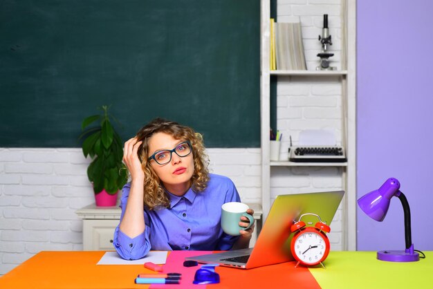 University student at campus female university student sits on desk young teacher in glasses over