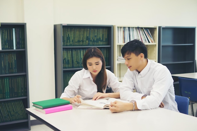 写真 図書館のテーブルで勉強する大学生