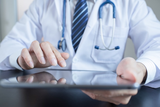 Unknown doctor using computer plane-table