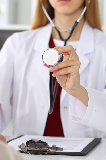 Unknown female doctor with a stethoscope in the hands Physician is redy to exemine a patient