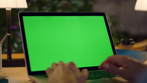 Photo unknown man hands working green screen computer guy typing on laptop in office