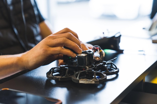 Unknown man turning on fpv drone at the shop professional photography