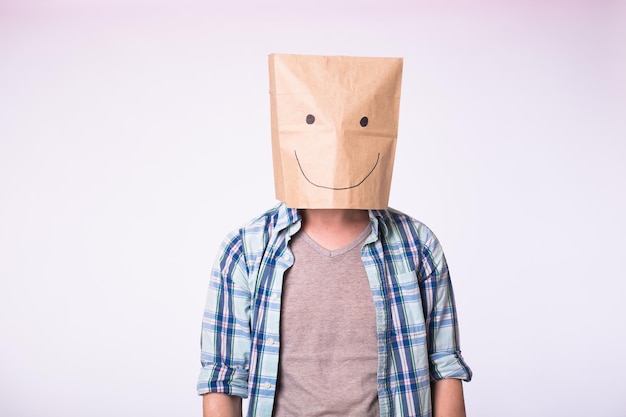 Photo unknown man with a paper bag on his head on white background