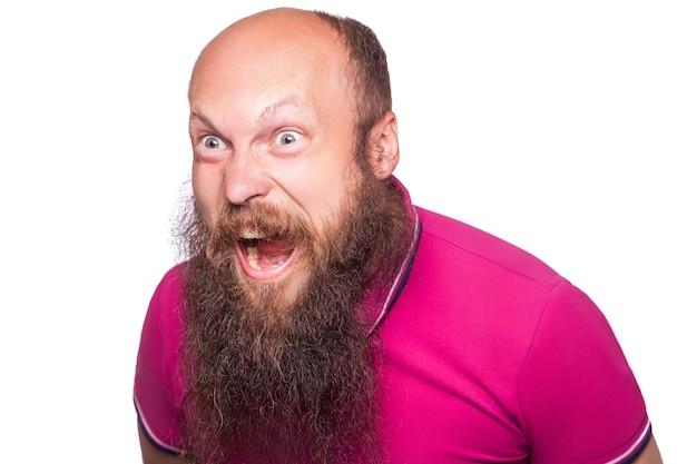 Unleashed emotions. Frustrated young man with blue opened eyes and mouth opened while standing looking at camera, isolated on white background.