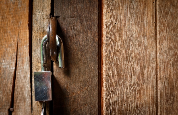 Unlock key on wooden door.Open lock concept.