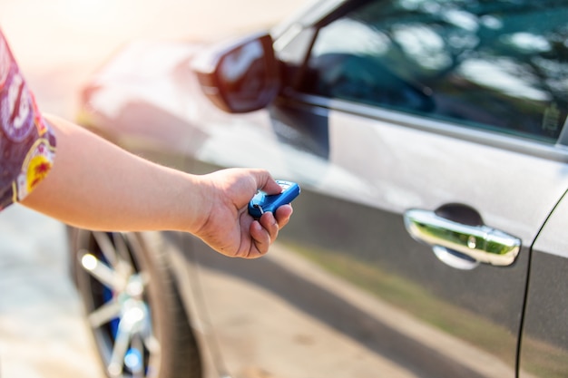 Unlocking car with car key.