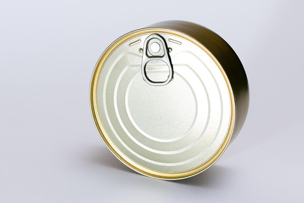 Unopened tin can with blank edge on white background