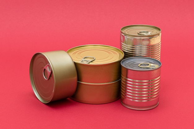 Unopened Tin Cans with Blank Edges on Red Background