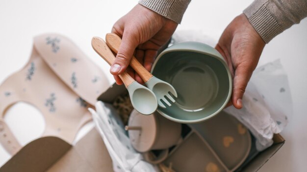 Photo unpacking baby products silicone dishes for first feeding