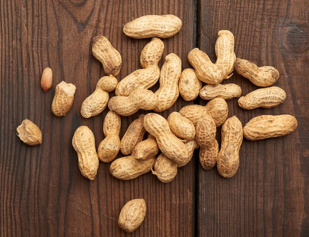 Unpeeled peanuts on a wooden table