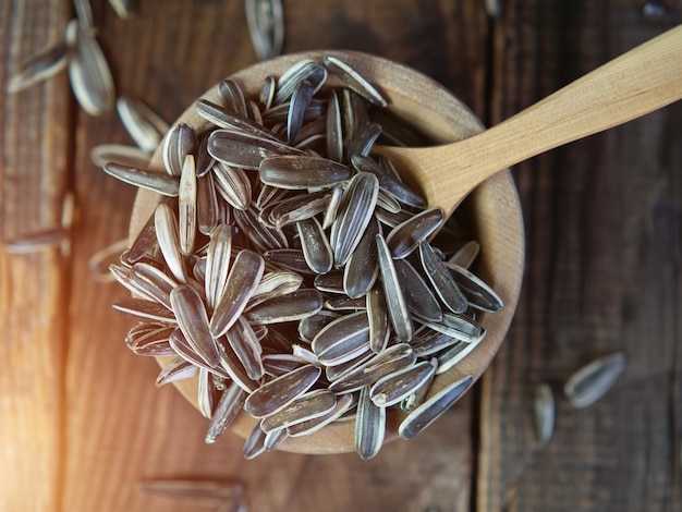 Unpeeled sunflower seeds on an old wooden table