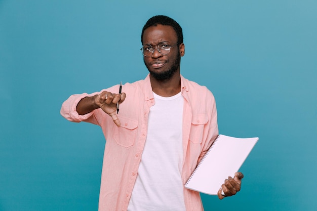 Unpleased showing thumbs down holding paper young africanamerican guy isolated on blue background