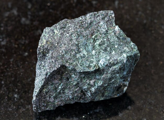 Photo unpolished magnetite ore on black