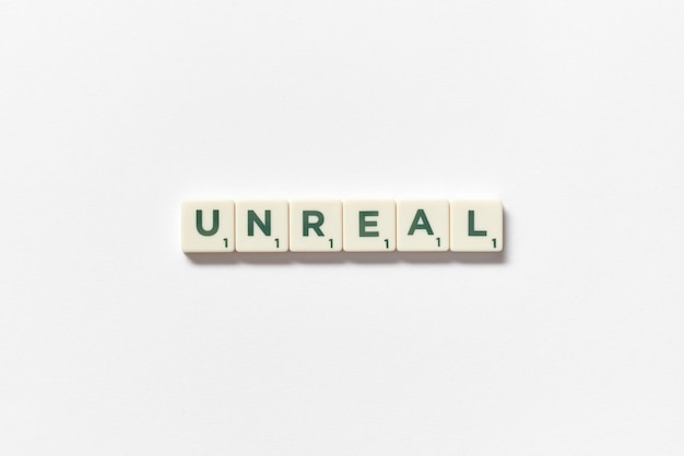 Photo unreal formed of scrabble blocks on white background