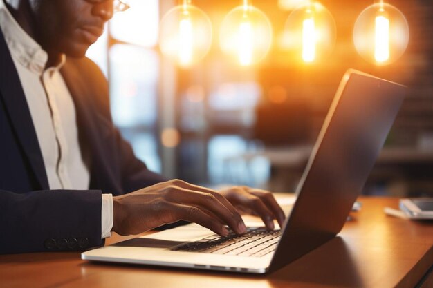 unrecognizable african american businessman with illuminated light bulb working on laptop at office