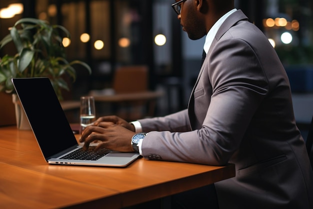 Unrecognizable african american manager working on laptop in office