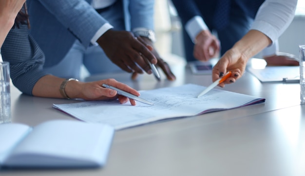 Unrecognizable business person analyzing graphs and taking notes