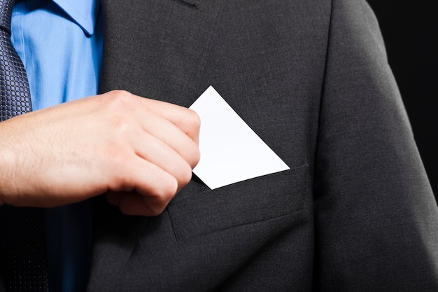 Unrecognizable businessman taking a greeting card from his pocket