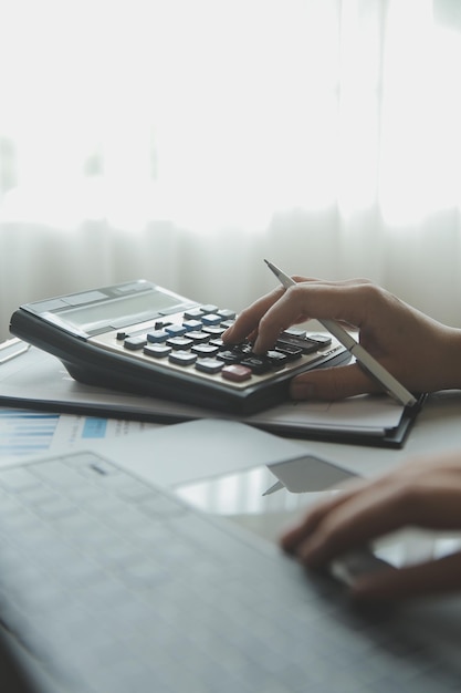 Unrecognizable businessman using calculator