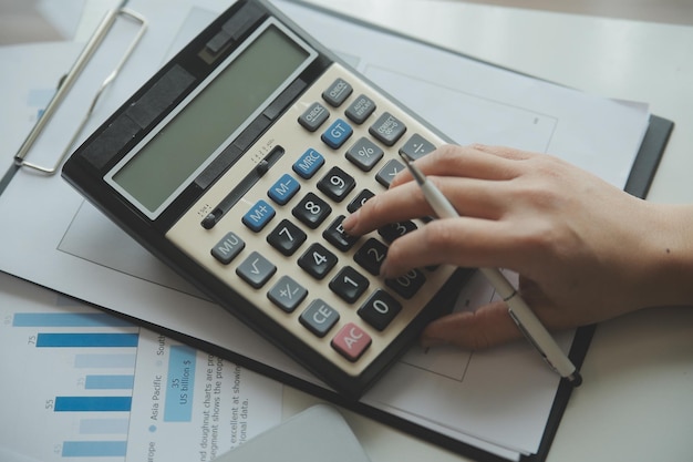 Unrecognizable businessman using calculator