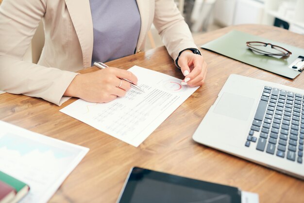 Photo unrecognizable businesswoman reading statistics report