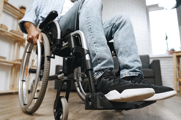 Photo unrecognizable disabled man sitting in a wheelchair