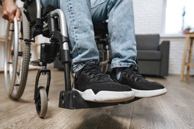 Photo unrecognizable disabled man sitting in a wheelchair