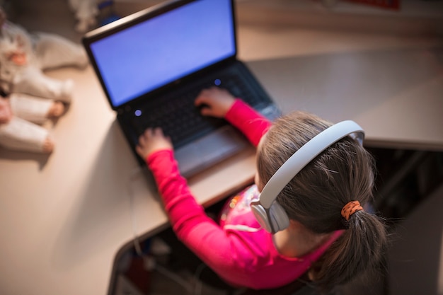 Unrecognizable girl using laptop