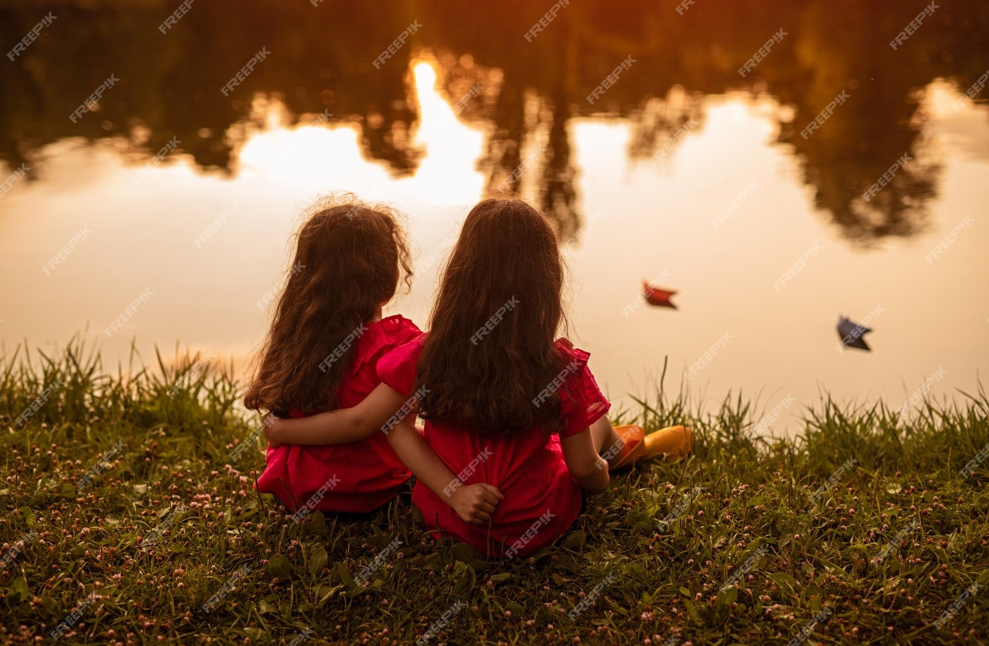 https://img.freepik.com/premium-photo/unrecognizable-girls-sitting-lake-shore-evening_251859-17037.jpg?w=2000