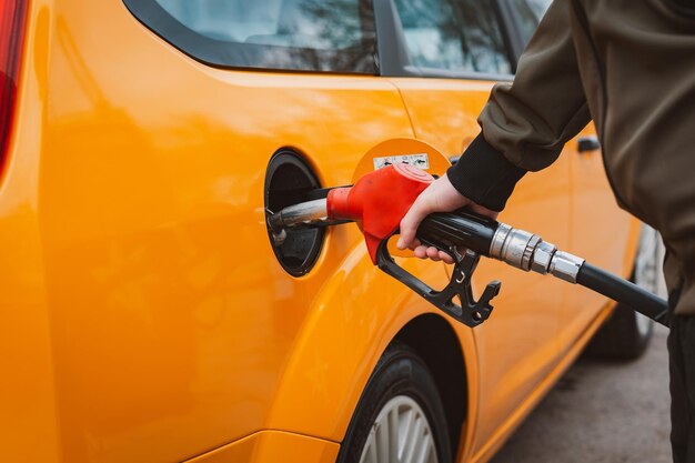 Unrecognizable man refueling car from gas station filling benzine gasoline fuel in car at gas station Petrol high prices concept