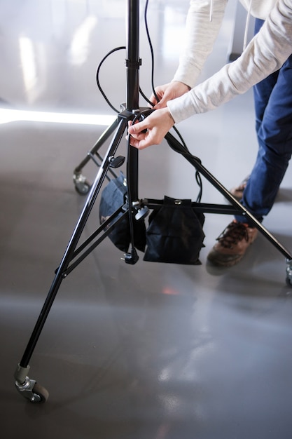 Unrecognizable man setting the photo tripod