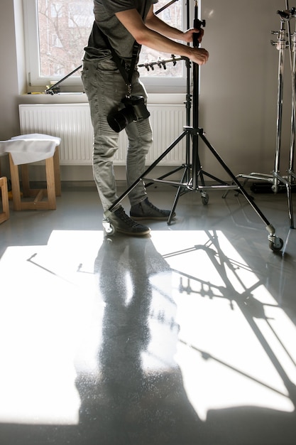 Unrecognizable man setting the photo tripod