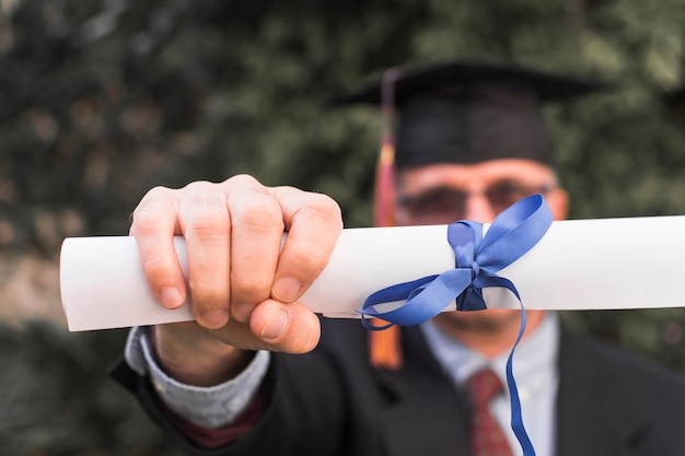 Photo unrecognizable man showing diploma