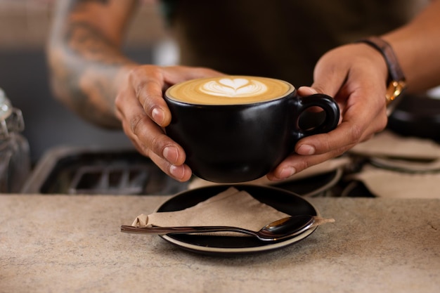 Unrecognizable man with a cup of cappuccino coffee