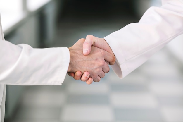 Unrecognizable medics shaking hands