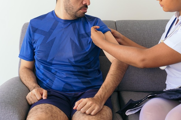 unrecognizable nurse measuring a man39s blood pressure at home