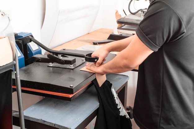 A unrecognizable person working on a iron sublimation. printing concept and graphic design.