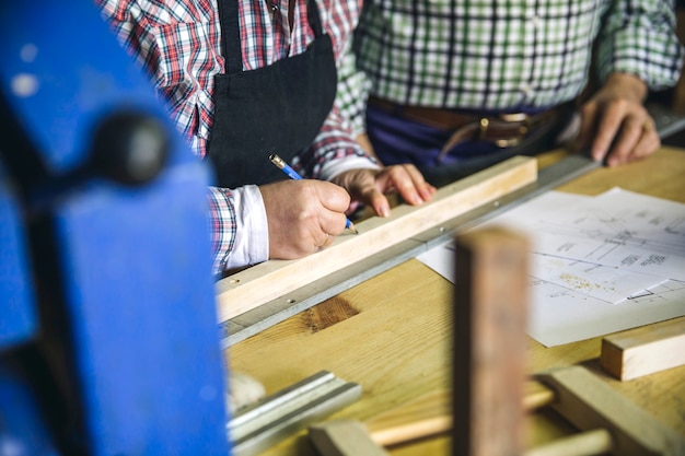 Unrecognizable senior couple working in a carpentry workshop