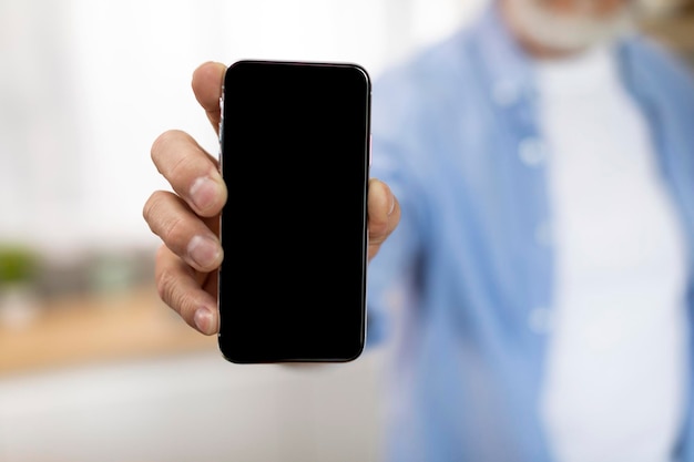 Unrecognizable Senior Man Holding Modern Smartphone With Big Blank Screen