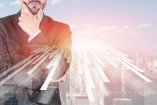 Unrecognizable thoughtful businessman standing in sunlit city with double exposure of immersive interface. Toned image