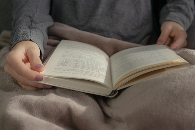 Unrecognizable woman holding a book in her hands